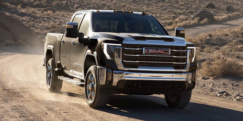 Front-angled view of 2025 GMC Sierra 2500 HD in the dessert